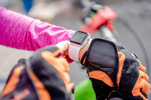 Sportiv alergand cu smartwatch cu GPS pe ecran, peisaj montan